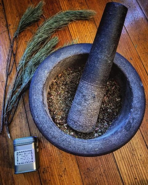 consecrated mortar and pestle with incense tins and greens